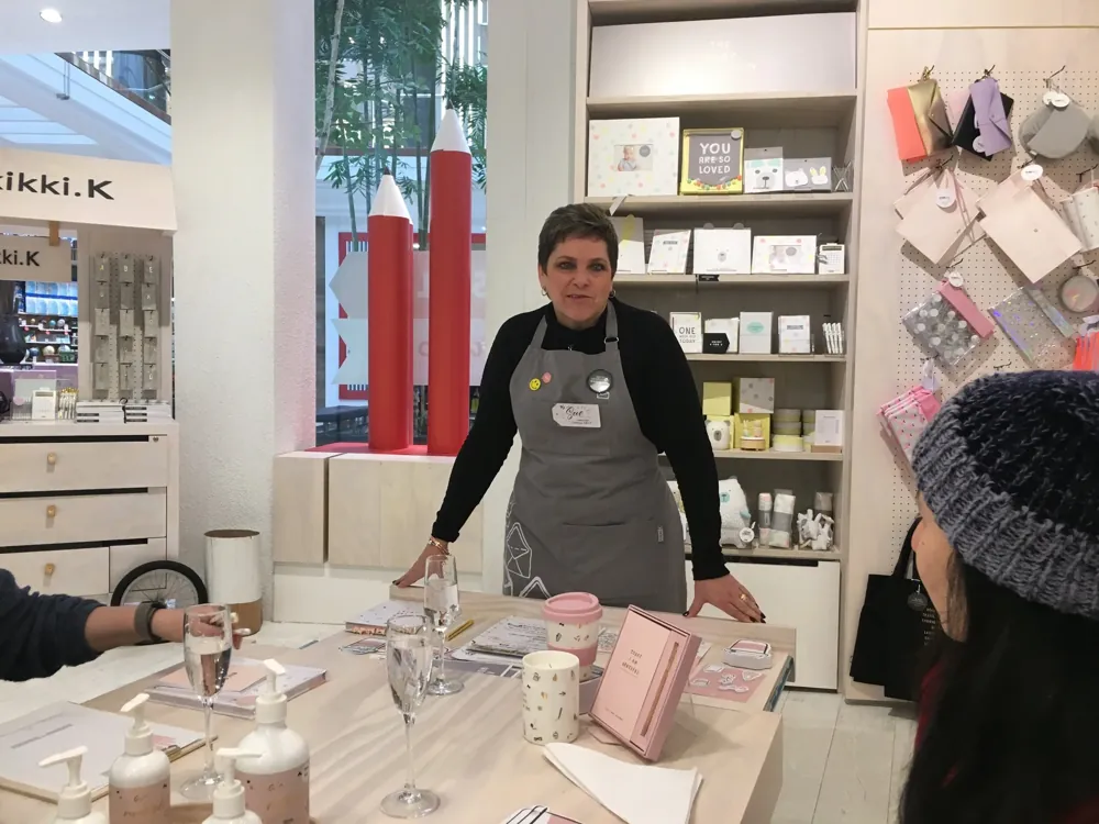 Sue running a goal-setting workshop around a table at kikki.K